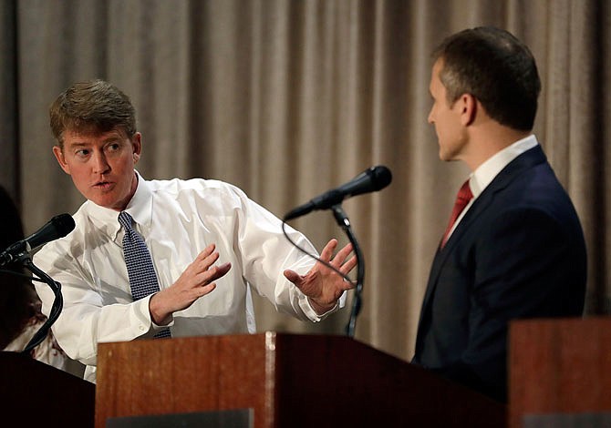 Democratic gubernatorial candidate Chris Koster, left, speaks to Republican challenger Eric Greitens during the Sept. 30 general election debate in the race for Missouri governor in Branson.