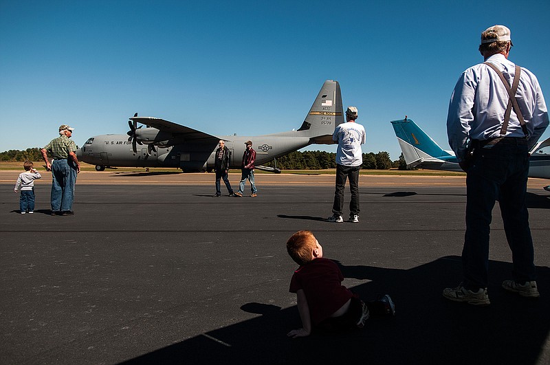 Visitors view an C-130 Hercules military cargo aircraft Saturday at the first fly-in at the Texarkana Regional Airport hosted by the local Experimental Aircraft Association chapter.