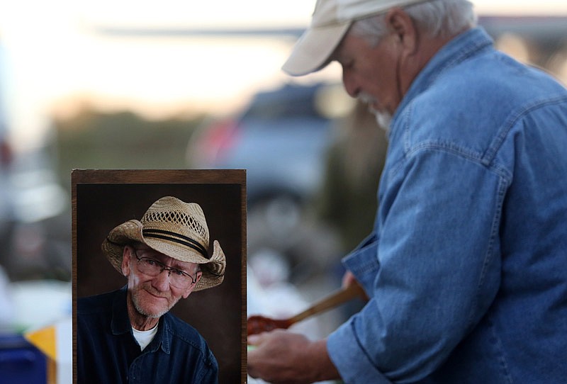 A portrait of Joe Wilson can be seen during his memorial service Saturday, Oct. 8, 2016 at the Missouri River access point in north Jefferson City, which was renamed Joe Wilson's Serenity Point in his honor.