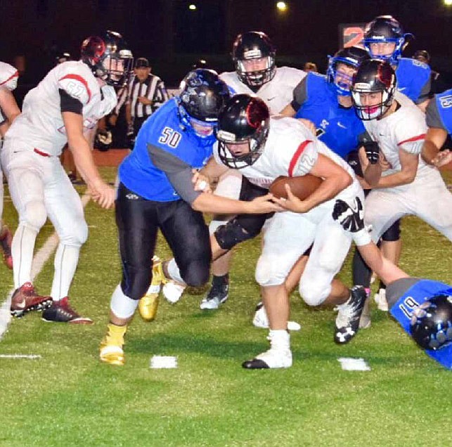 South Callaway senior defensive lineman Braeden Sconce tries to bring down Clopton/Elsberry senior quarterback Stephen Talbert during the Bulldogs' 62-30 EMO victory over the IndianHawks on Friday night in Mokane, Mo.