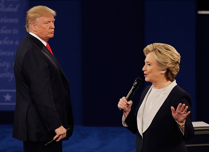 Republican presidential candidate Donald Trump listens as Democratic candidate Hillary Clinton makes a point during their second debate Sunday night.