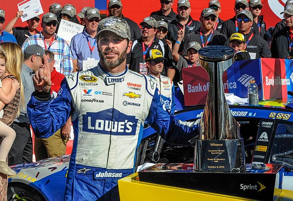 Jimmie Johnson celebrates in victory lane after winning Sunday's NASCAR Sprint Cup Series race at Charlotte Motor Speedway in Concord, N.C.