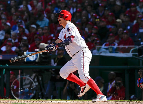 Nationals catcher Jose Lobaton drops his bat after connecting for a three-run home run off Dodgers pitcher Rich Hill during the fourth inning in Game 2 of the National League Division Series on Sunday at Nationals Park in Washington.