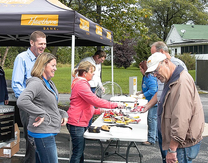 At the Hawthorn Bank Customer Appreciation Day, bank employees serving customers, are, from left, Becky Lawson, Shawn Ehrhardt, Kendra Fisher, Lance Stegeman, and, across from Stegeman, Jenny Brown.