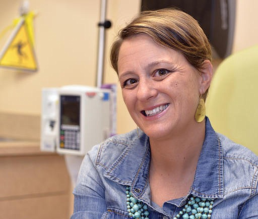 Lara MacGregor, a participant in a new crowdsourcing project for metastatic breast cancer research, poses for a photo as she undergoes treatment at the Norton Cancer Center in Louisville, Ky., on Wednesday, Sept. 21, 2016. In just the first year, more than 2,600 affected patients have enrolled in the project, submitting samples and medical records by mail. "I hope that real data about real people is going lead to better treatment options," she says. "My life depends on it." 