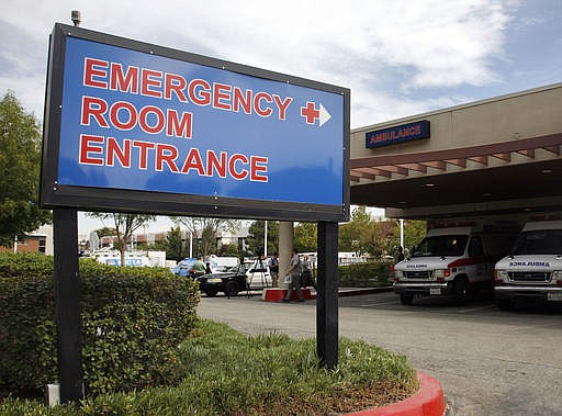 This Friday, Sept. 30, 2011 file photo shows an emergency room entrance at a hospital in Santa Clarita, Calif. In a study published on Wednesday, Oct. 5, 2016 researchers found that about 17 years after a heart attack, life expectancy was 9 to 14 months longer for those who had been treated at hospitals that do best on widely used quality measures than for those at low-rated ones. 