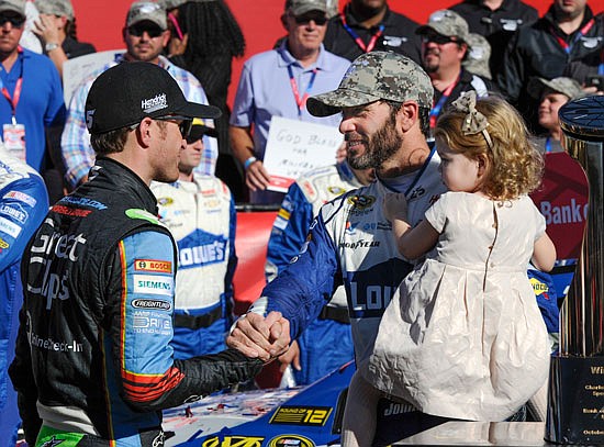 Kasey Kahne (left) congratulates teammate Jimmie Johnson after Johnson won the Sprint Cup Series race Sunday at Charlotte Motor Speedway in Concord, N.C.