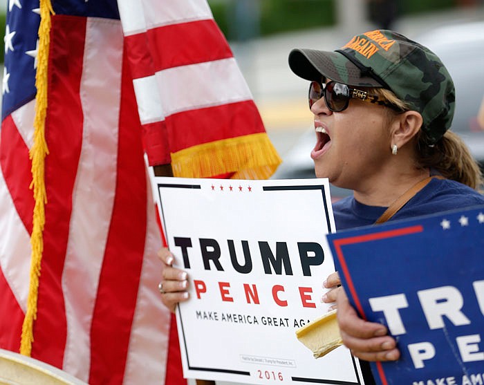 Cuban-born Lilia Morraz of Miami, demonstrates with other supporters of Republican presidential candidate Donald Trump outside a rally for Democratic presidential candidate Hillary Clinton, and former vice president Al Gore in Miami.