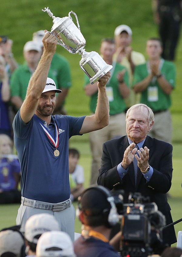 In this June 19 file photo, Dustin Johnson holds the trophy as Jack Nicklaus looks on after winning the U.S. Open at Oakmont Country Club in Oakmont, Pa. Johnson won the PGA Tour player of the year award Tuesday.
