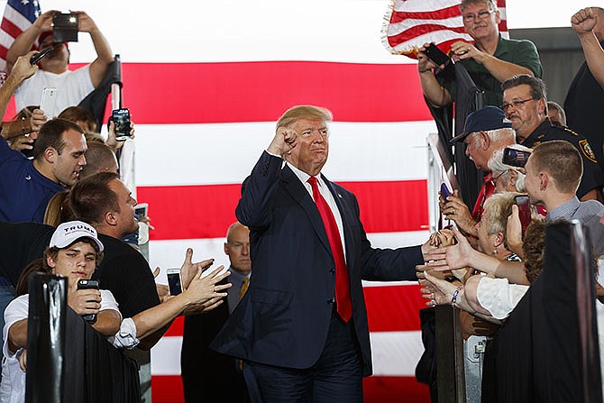 Republican presidential candidate Donald Trump gestures as he arrives to speak at a campaign rally Wednesday in Ocala, Florida.