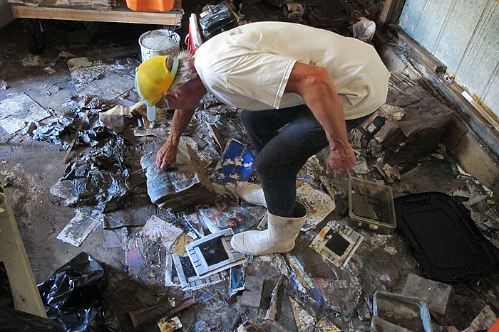 Walter Coker surveys the damage in his furniture storage shed in Crescent Beach, Fla. Coker runs Genung's Fish Camp and Marina on the shore of the Matanzas River, and saw storm surge from Hurricane Matthew run "like a river" through his property, tearing apart the storage shed and the tackle shop. He doesn't have flood insurance because he said it was too expensive, so is hoping to rebound with the help of neighbors and the community. 