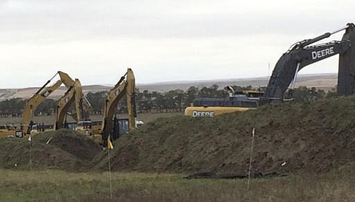 Excavators are in place as work resumed Tuesday, Oct. 11, 2016, on the four-state Dakota Access pipeline near St. Anthony, N.D. A federal appeals court ruling on Sunday cleared the way for work to resume on private land in North Dakota that's near a camp where thousands of protesters supporting tribal rights have gathered for months. 