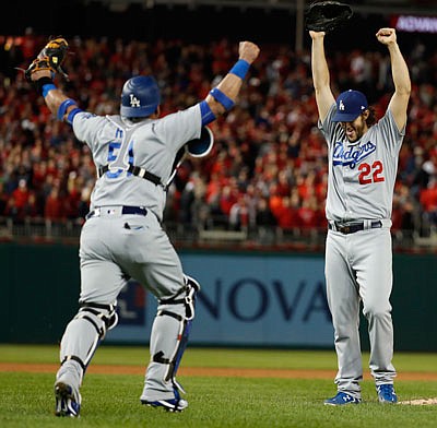 Dodgers pitcher Clayton Kershaw and catcher Carlos Ruiz celebrate after Thursday night's win in Game 5 of the NLDS against the Nationals in Washington.