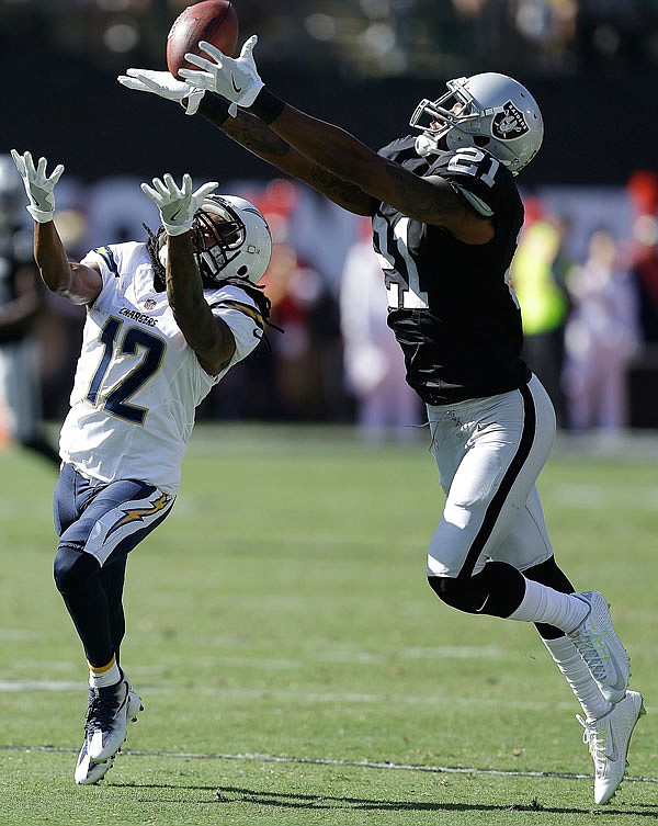 Raiders cornerback Sean Smith intercepts a pass intended for Chargers wide receiver Travis Benjamin during last Sunday's game in Oakland, Calif.