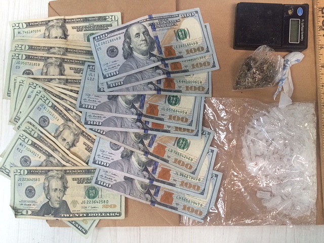 Ashdown, Ark., police display $1,100 cash and crystal methamphetamine valued at $4,450. The money and drugs were confiscated during a raid of a house on the west side of Ashdown.