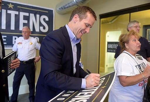 In this Aug. 26, 2016 file photo, Missouri Republican gubernatorial candidate Eric Greitens meets with supporters in downtown St. Joseph, Mo. 