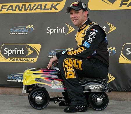 Matt Kenseth sits on the Kansas Speedway pole award Friday after winning the pole position for Sunday's Sprint Cup race in Kansas City, Kan.