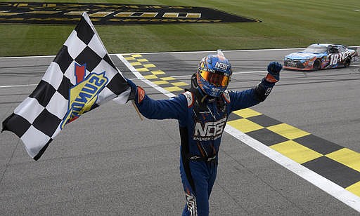 NASCAR driver Kyle Busch celebrates after winning an Xfinity series auto race at Kansas Speedway in Kansas City, Kan., Saturday, Oct. 15, 2016.