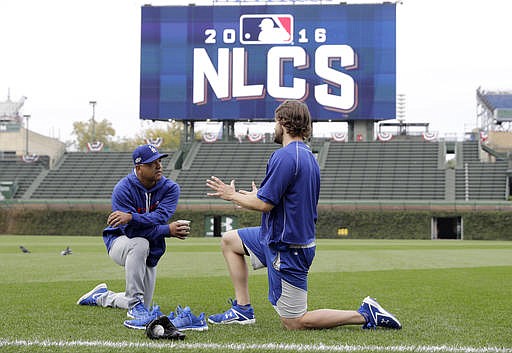 Los Angeles Dodgers manager Dave Roberts, left, talks to Clayton Kershaw as players warm up before Game 1 of baseball's National League Championship Series against the Chicago Cubs, Saturday, Oct. 15, 2016, in Chicago. 