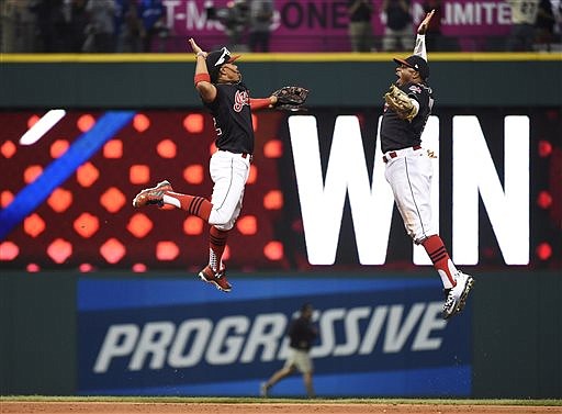 Cleveland Indians shortstop Francisco Lindor, left, and center fielder Rajai Davis celebrate their 2-1 win against the Toronto Blue Jays in Game 2 of baseball's American League Championship Series in Cleveland, Saturday, Oct. 15, 2016.