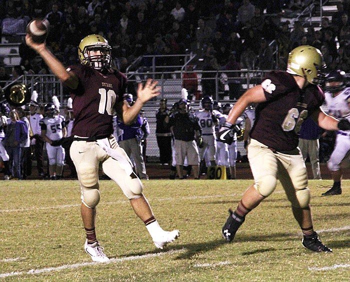 Eldon quarterback Austin Kempker lofts a pass into the right corner of the end zone to Morgan Anderson for a 12-yard touchdown against Hallsville Friday, Oct. 14, 2016 during their Tri-County Conference game in Eldon.