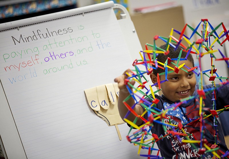 Henry Zavala uses a "breathing ball" as he and classmates take part in mindfulness exercises Sept. 19 at Davis Elementary in Carrollton, Texas. 
