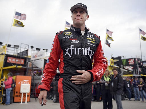 Carl Edwards walks to his garage for the start of practice for the NASCAR Sprint Cup Series auto race at Kansas Speedway in Kansas City, Kan., Saturday, Oct. 15, 2016. 