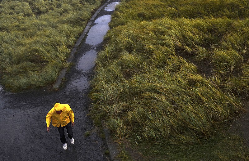 A park visitor battles stormy conditions on Saturday at Fort Stevens State Park in Hammond, Ore.v