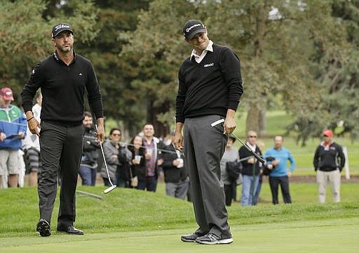 Johnson Wagner, right, reacts after missing a birdie putt on the seventh green of the Silverado Resort North Course as Scott Piercy, left, looks on during the third round of the Safeway Open PGA golf tournament Saturday, Oct. 15, 2016, in Napa, Calif. 