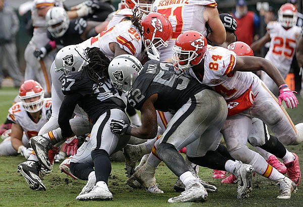 Dontari Poe (92) of the Chiefs fights his way to the end zone for a touchdown during Sunday's game against the Raiders in Oakland, Calif.