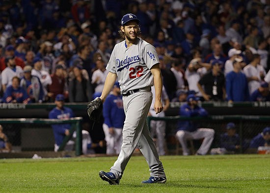 Dodgers starting pitcher Clayton Kershaw smiles as he walks off the mound after the seventh inning of Sunday night's game against the Cubs in Chicago.