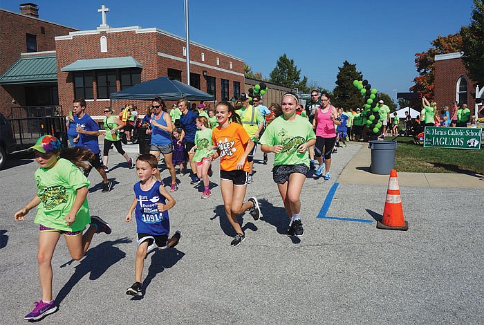 Youngsters bolt to the lead at the start of  St. Martin School's first Goblin 5K race on Sunday. About 200 people registered for the Halloween-themed race, which the school hopes to make an annual fundraiser fot the Home and School Association. 