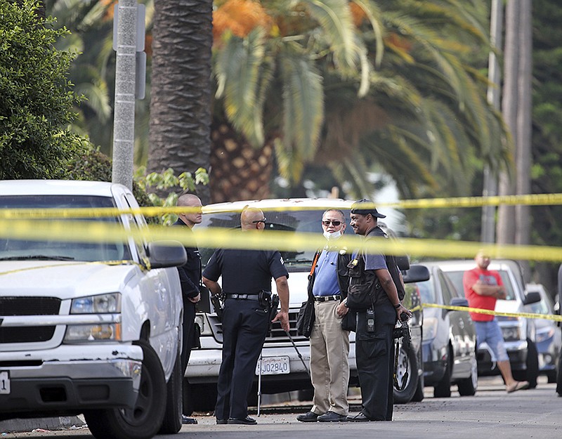 Los Angeles police investigators work the scene of a fatal shooting Saturday in the Crenshaw District neighborhood of Los Angeles. According to police an early morning argument at a restaurant triggered gunfire.