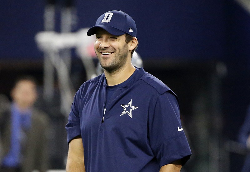Dallas Cowboys quarterback Tony Romo smiles as he walks across the field Sept. 25 during pregame warm-ups against the Chicago Bears in Arlington, Texas. Cowboys coach Jason Garrett said he didn't anticipate Romo for the only practice this week on Wednesday, which means the earliest Dallas' 10-year starter could practice would be four days before the Philadelphia game. In that case, the Nov. 6 visit to Cleveland is a more likely potential return date