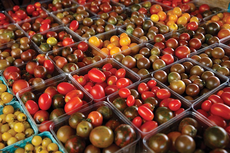 A variety of miniature tomatoes are displayed for sale Aug. 1, 2015, at a farmers market in Falls Church, Va. 