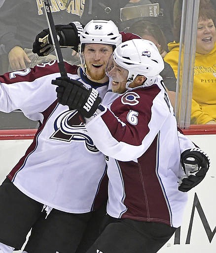 Colorado Avalanche defenseman Erik Johnson (6) congraulates Colorado Avalanche left wing Gabriel Landeskog (92) on his game winnging goal during the overtime period of an NHL hockey game against the Pittsburgh Penguins on Monday, Oct. 17, 2016, in Pittsburgh. The Avalanche defeated the Penguins 4-3. 