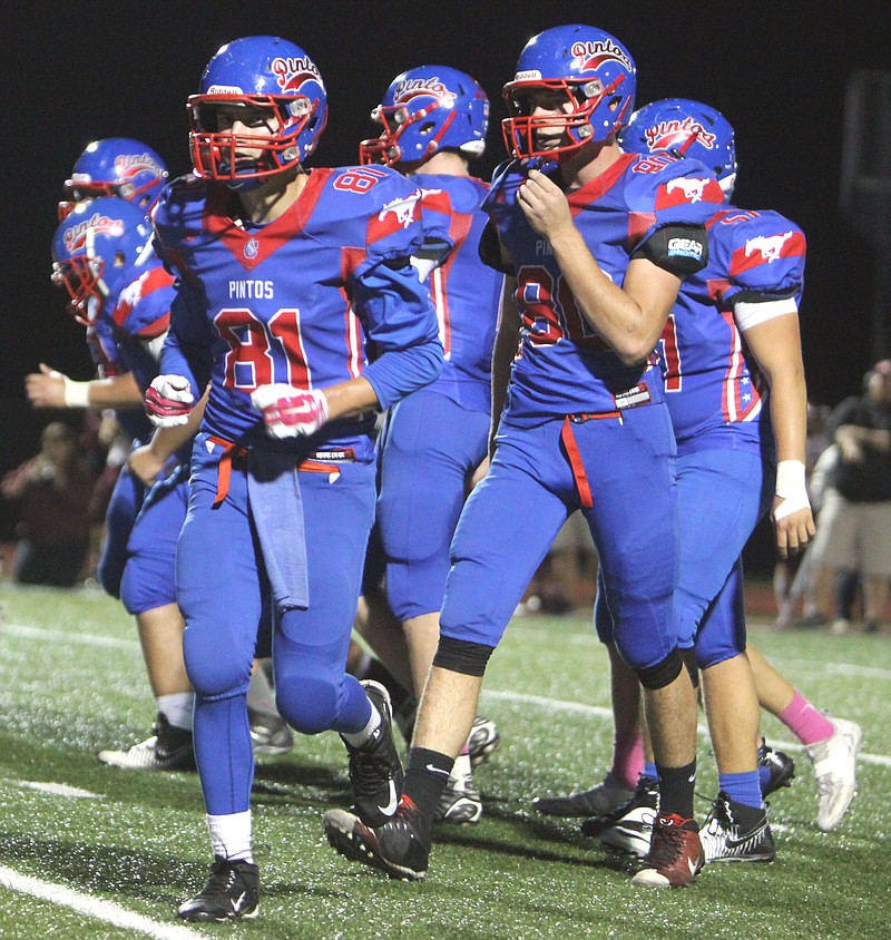 The California offense breaks its huddle early in Friday's 40-19 loss to Osage.