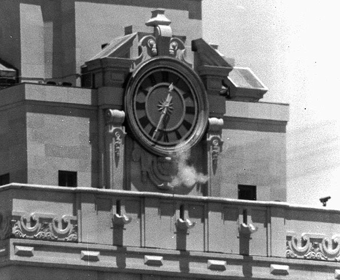 Smoke rises from the sniper's gun as he fired from the tower of the University of Texas administration building Aug. 1, 1966, in Austin, Texas, on crowds below. Police identified the slayer as Charles Whitman, a student at the university. 