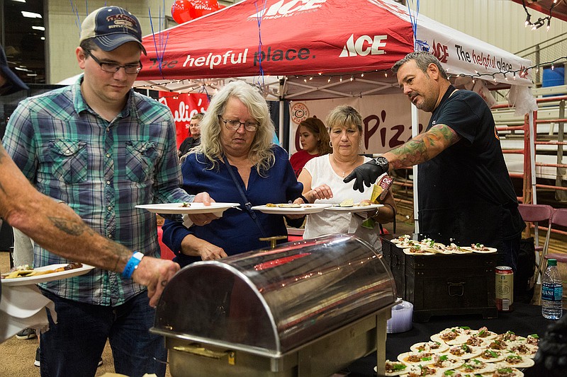 Jeff Loving of Twisted Fork offers brisket tacos Tuesday during Taste of Texarkana at the Four States Fairgrounds. The event features local restaurants, national chains and grocery stores. 