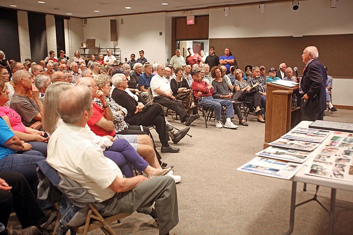 Veterans and patrons gather to listen to veteran William Miller, right, speak about his experiences in the Korean War, as a program in conjunction with Operation Bugle Boy at the Missouri Regional River Library.