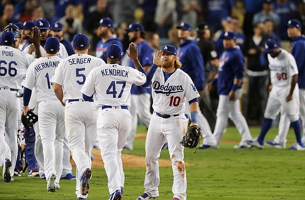 The Dodgers celebrate Tuesday night after winning Game 3 of the National League Championship Series against the Cubs in Los Angeles.