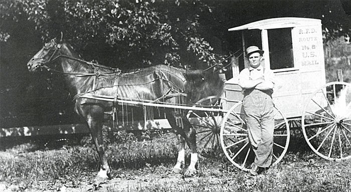 Walter Harrison, a rural mail carrier from Auxvasse, poses next to his buggy, around 1910.