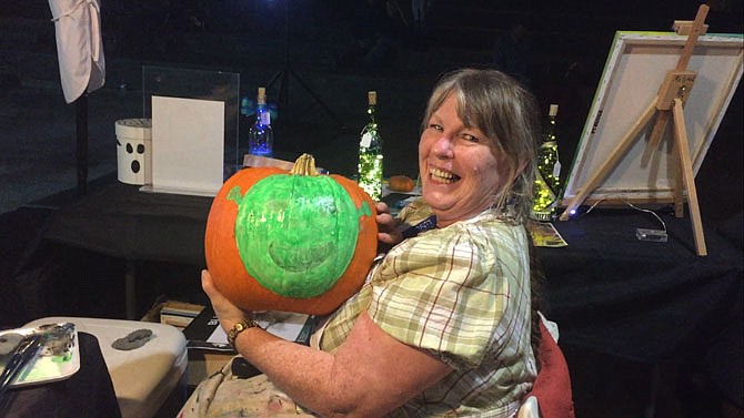 Kathleen Dake shows off her painted pumpkin at a recent Evening at the Amphitheatre event.