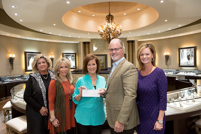 Shane Woodruff owner of Crocker's Jewelers and store manager Melissa Douglass present Kim Johnson, Jeanna Rogers co-chairs of the Cattle Barons Ball and Christal Prince a check for $1050 from Shopping for a Cure held at Crocker's. The money will go to the American Cancer Society. 
