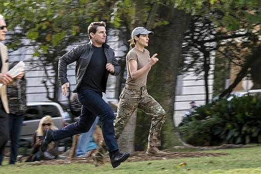 In this image released by Paramount Pictures, Tom Cruise, left, and Cobie Smulders appear in a scene from "Jack Reacher: Never Go Back." (David James/Paramount Pictures and Skydance Productions via AP)