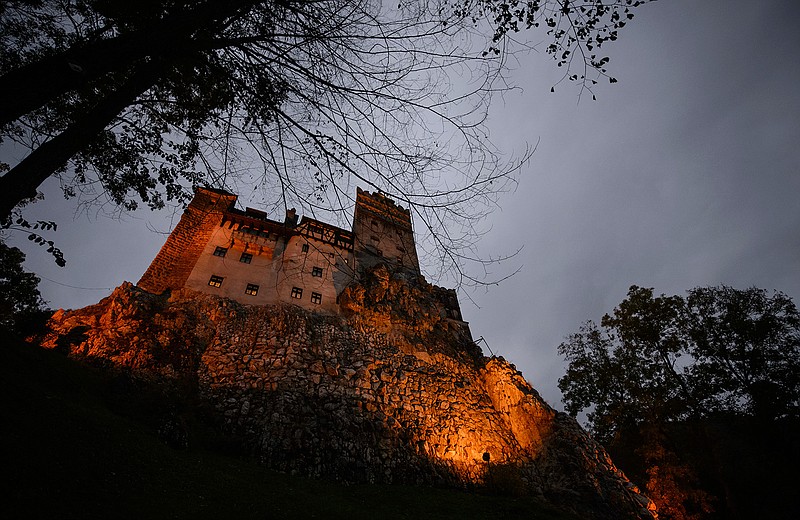 In this picture taken Oct. 9, 2016, Bran Castle lies on top of cliffs in Bran, Romania. Airbnb has launched a contest to find two people to stay overnight in the castle on Halloween, popularly known as Dracula's castle because of its connection to the cruel real-life prince Vlad the Impaler, who inspired the legend of Dracula.  