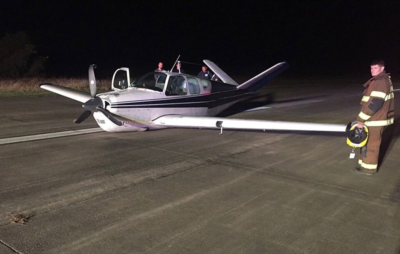 Eldon firefighters assist at the scene of a single-engine airplane that had to make an emergency landing without landing gear Monday, Oct. 17, 2016 at the Eldon airport. (Courtesy of Eldon Firefighters Association)