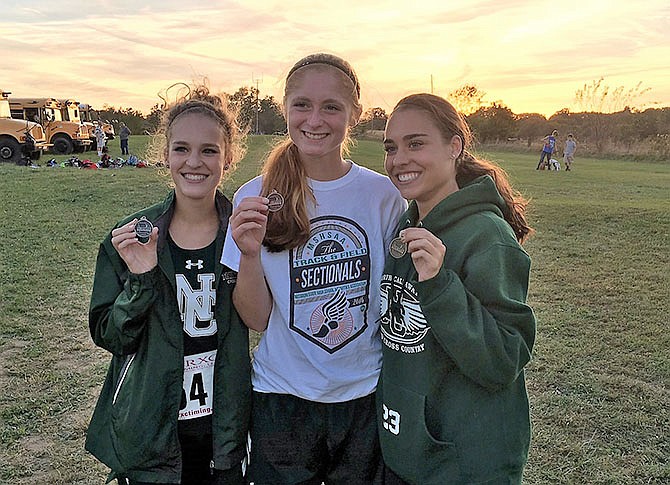 From left, Daelyn Schmauch Kyla Bertschinger and Reyna Schmauch finished in the top six at Monday's conference championship.