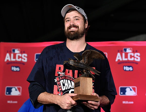 Indians relief pitcher Andrew Miller accepts the MVP trophy for the series after the Indians defeated the Blue Jays 3-0 in Wednesday's Game 5 of the American League Championship Series in Toronto.