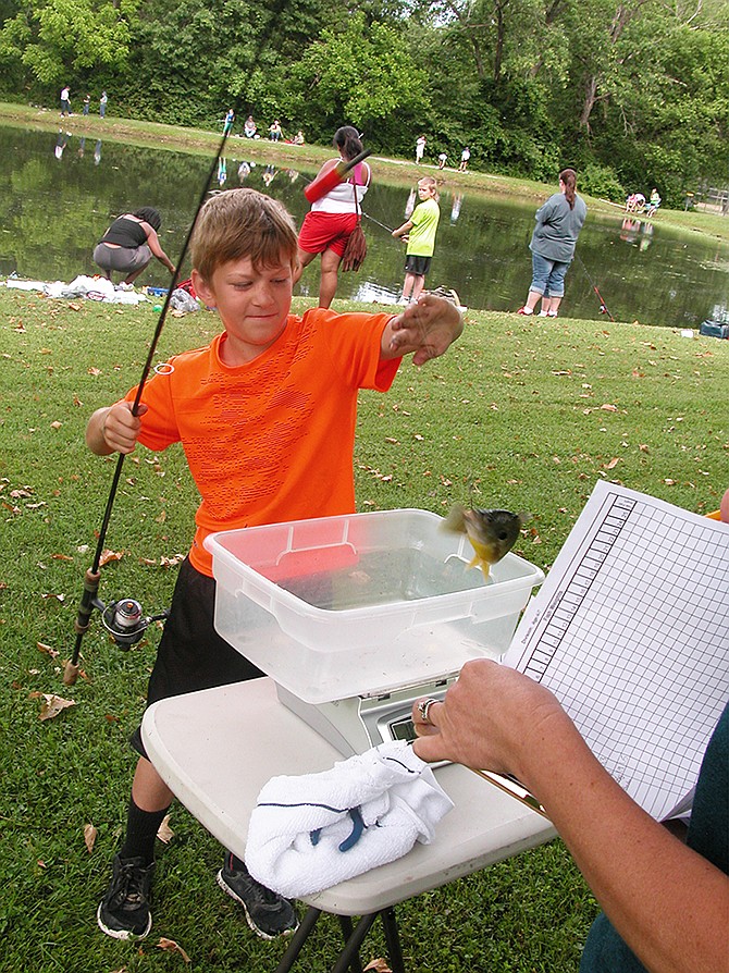 Noah Kinney weighs in at June's Alan Leake Memorial Kids Fishing Tournament at Veterans Lake. 